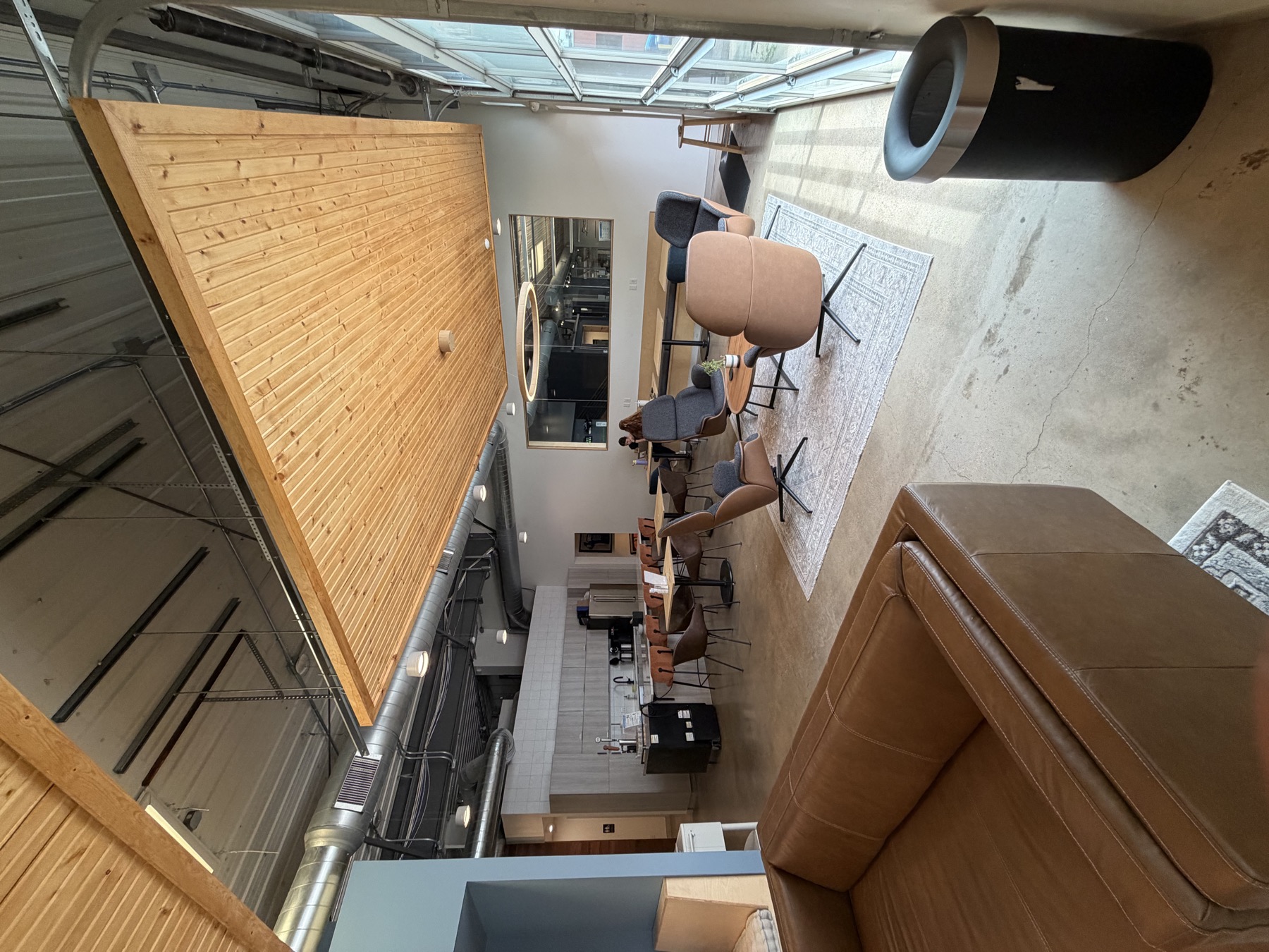 Open lounge with seating and kitchen beyond